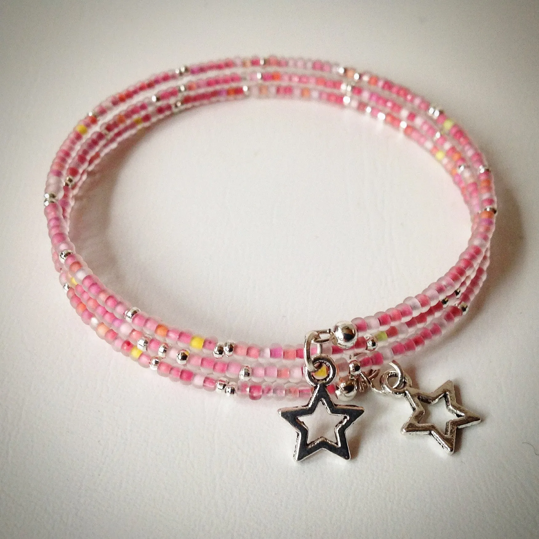 Beaded memory wire bracelet - silver and pink frosted seed beads and star pendants