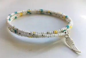 Beaded memory wire bracelet - white, turquoise, yellow and silver beads with angel wing pendant